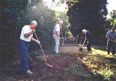 Congregation members Aron and Arkadij help clean up our land.